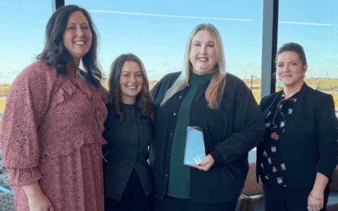 Heartland Whole Health Institute policy & workforce team stand with Amy for a photo with her award.