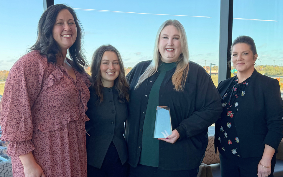 Heartland Whole Health Institute policy & workforce team stand with Amy for a photo with her award.