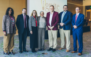 Superintendents stand for a posed photo with Alice Walton.